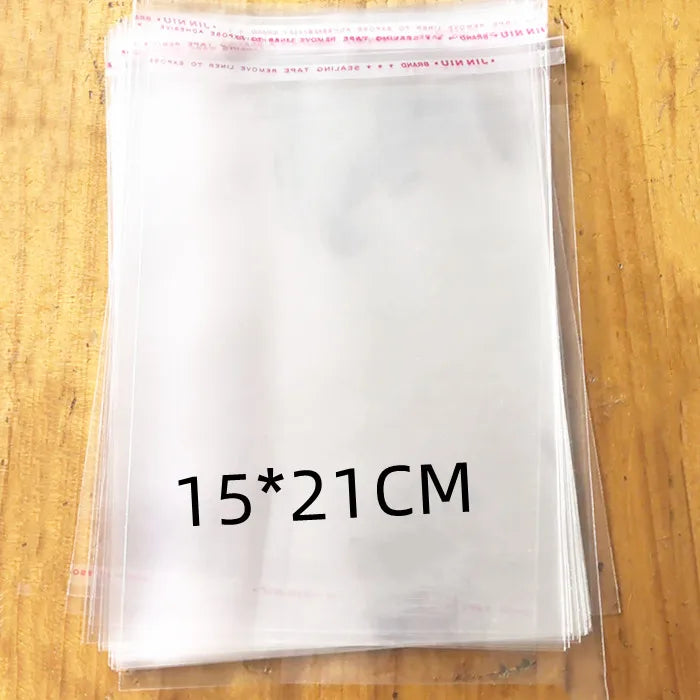 A stack of clear self-sealing plastic bags for jewelry, candy, and gifts is shown on a wooden surface.