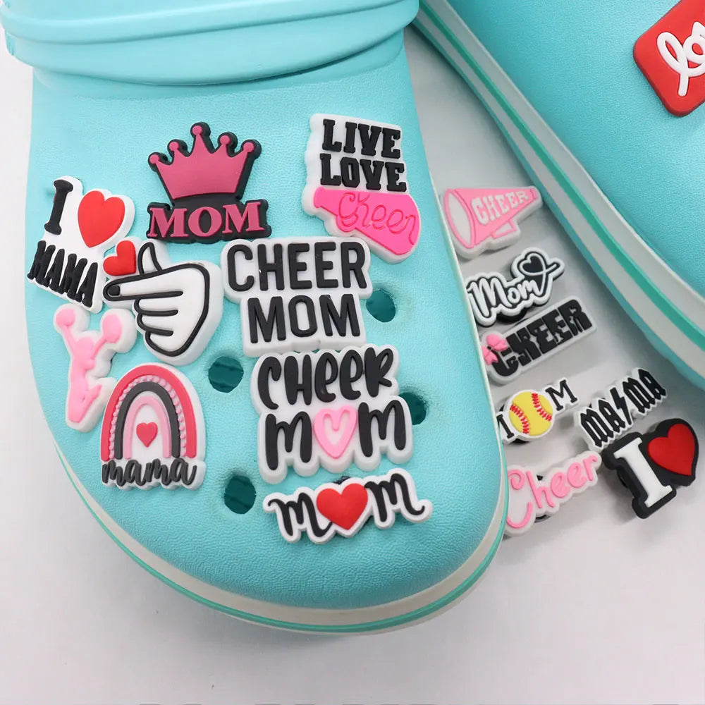 A collection of pink and white die-cut shoe charms featuring words like I Love Mom Cheer Mom and Mama