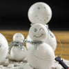 A close-up of white foam balls decorated with silver tinsel, used as a 3-in-1 electric foam cutting tool.
