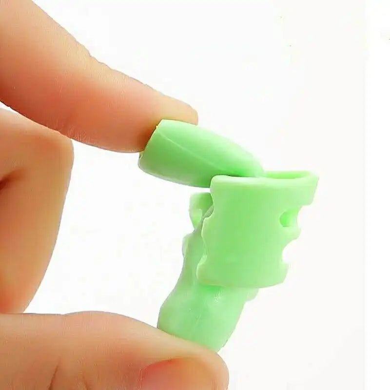 A hand is holding a light green ergonomic silicone pencil grip designed for children's handwriting aid.