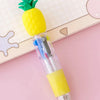 A yellow pineapple shaped pen with a green top and a yellow body, resting on a pink surface.