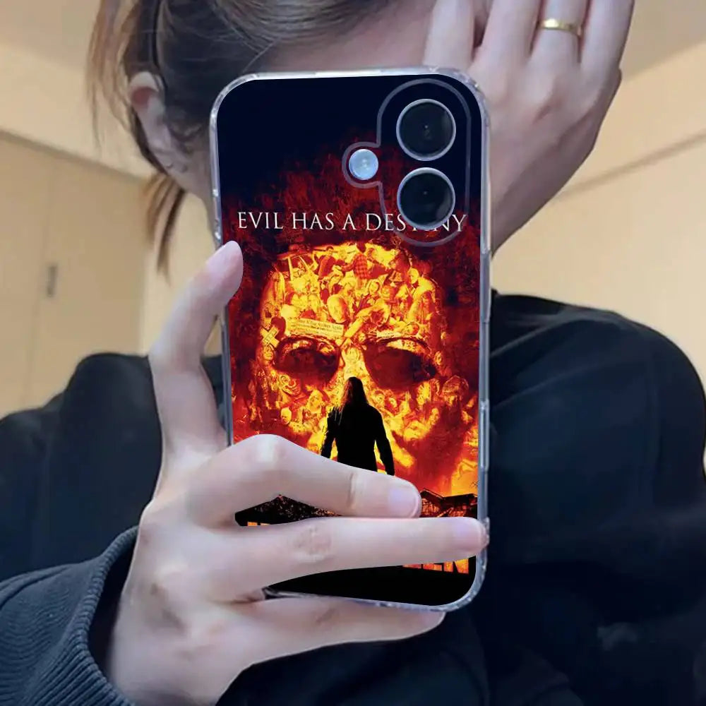 A hand holds an iPhone case featuring a menacing, fiery mask design inspired by Michael Myers for Halloween.