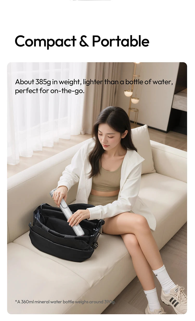 A woman is using a compact black portable water bottle on a sofa.