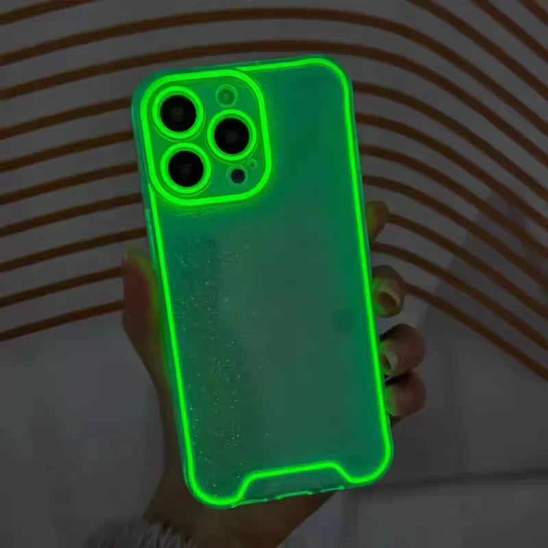 A hand holds a luminous neon green clear phone case for an iPhone, displaying the camera module and body.