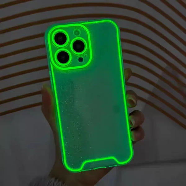 A hand holds a luminous neon green clear phone case for an iPhone, displaying the camera module and body.