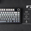 A close-up view of the F75MAX mechanical keyboard with a screen, showing its layout and features.