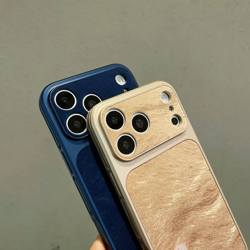 A close-up of two phone cases, one blue and one gold, showing the luxury frosted velvet texture.
