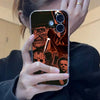 A hand holds an iPhone case featuring a horror theme, including a mask and knife imagery.