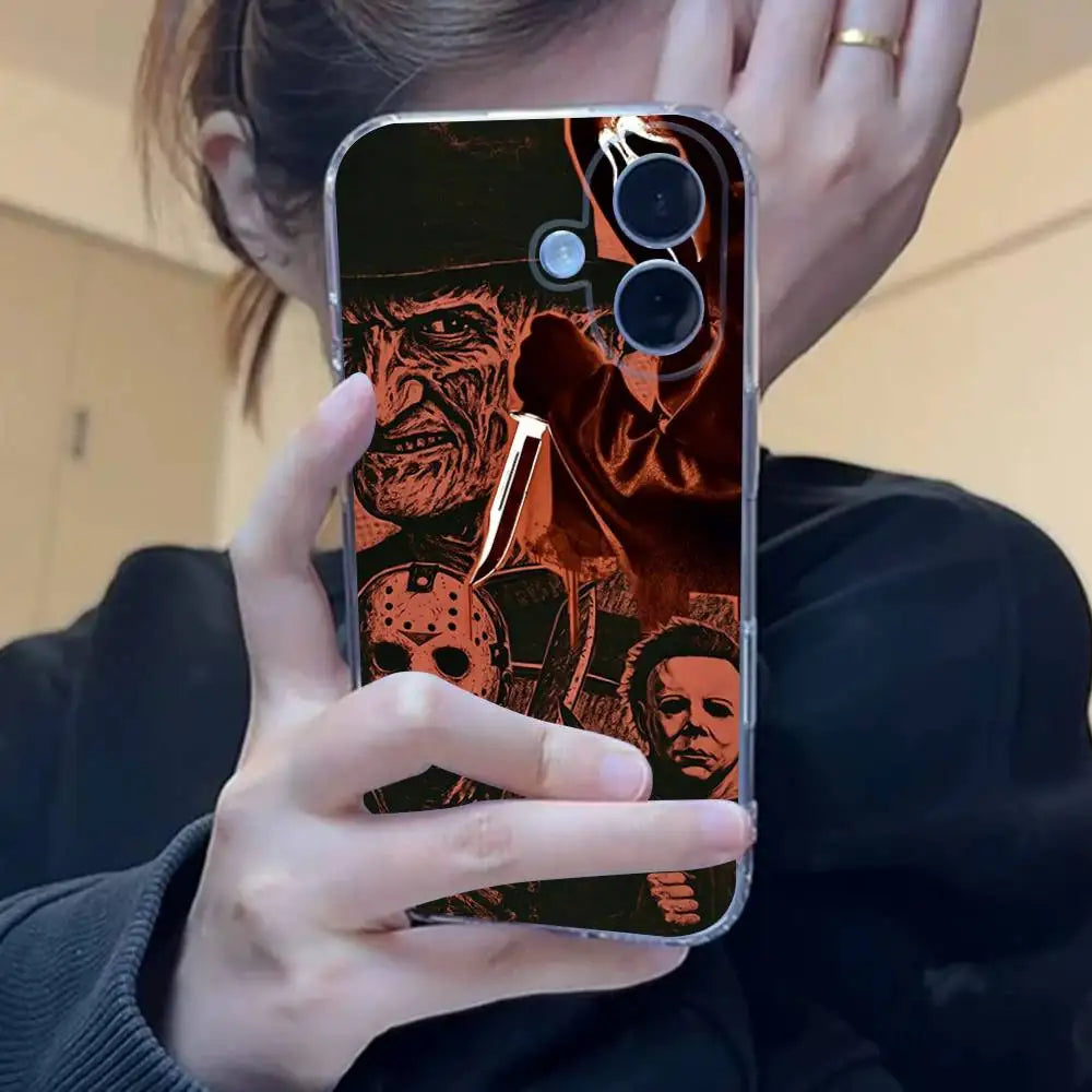 A hand holds an iPhone case featuring a horror theme, including a mask and knife imagery.