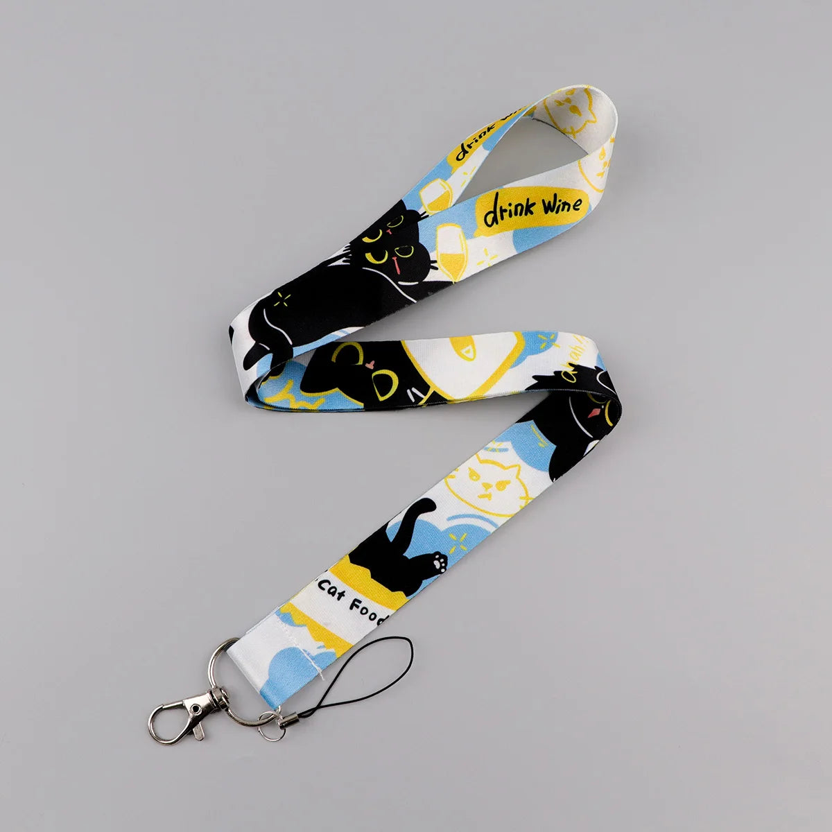 A yellow and black patterned cat print lanyard with a metal clip and card holder.