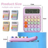 A pink 12-digit desktop calculator with multiple color options is shown on a blue surface.