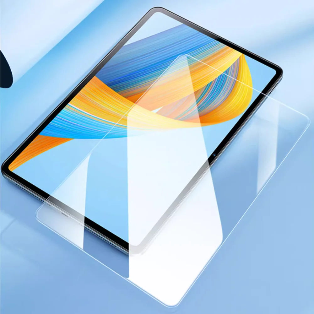 A clear tempered glass screen protector is shown placed on a tablet screen displaying colorful abstract lines.