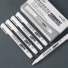 A box of White Permanent markers with twelve pens and a single pen displayed on a gray surface.