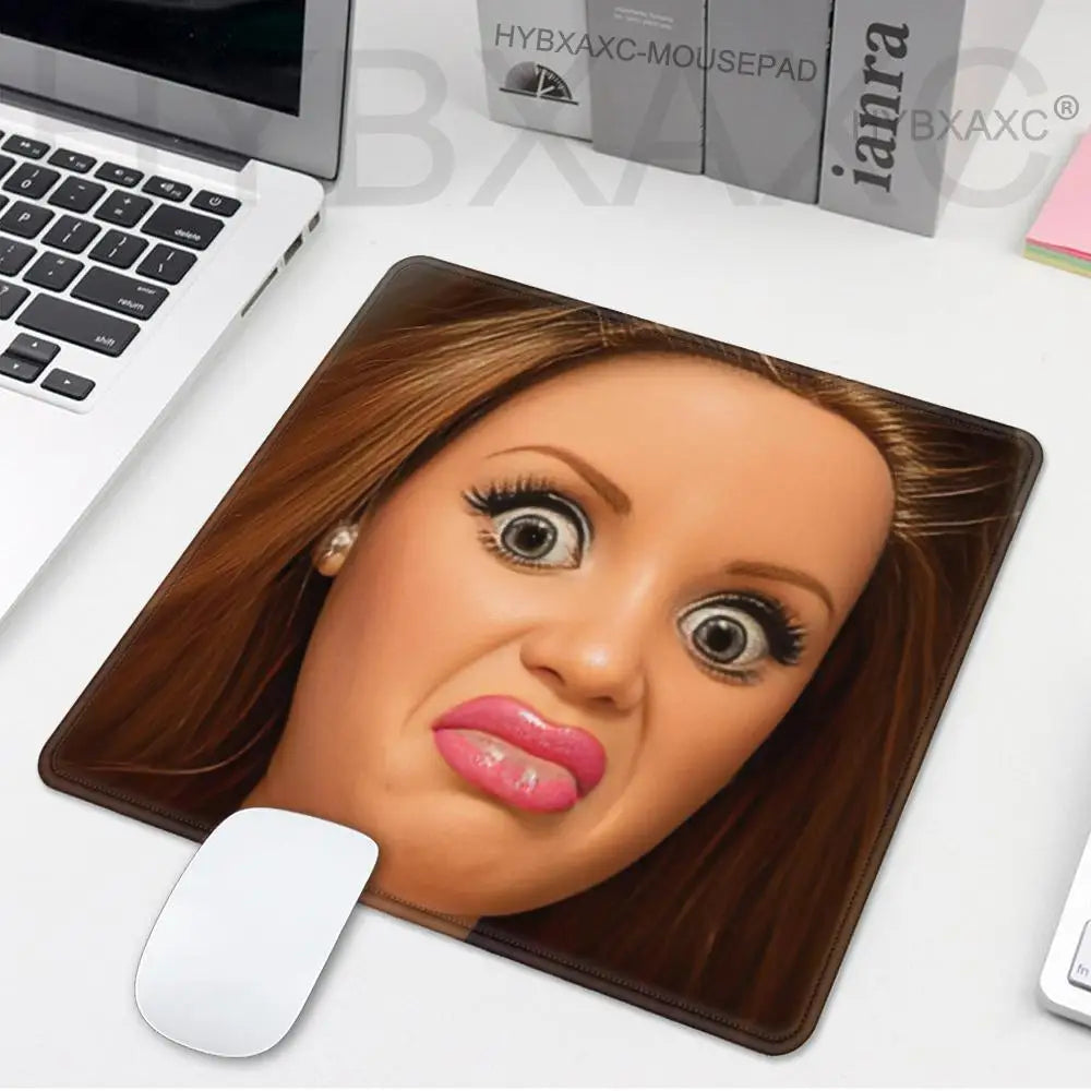 A realistic doll face sculpture used as a desk mouse pad with a brown hair appearance.