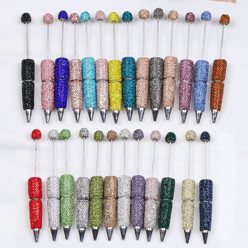 A collection of 20 rhinestone beaded pen accessories in various colors and finishes.