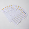 A stack of A6 budget sheets with envelope pockets and expense sheets in yellow and gray tones.
