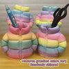 Two pink and purple puffer jacket pen holders with colorful gradient fabric are shown on a wooden surface.