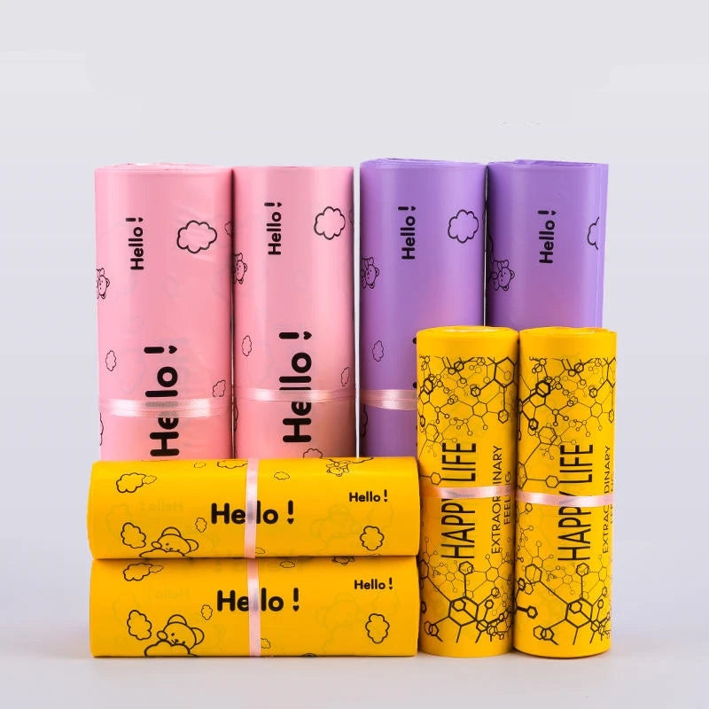 A collection of colorful reusable plastic mailing bags in pink, purple, and yellow.