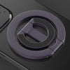 A close-up view of a purple MagSafe double-sided phone ring holder on a dark surface.