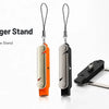 An orange and silver 2-in-1 invisible phone charger stand with foldable legs and a detachable USB-C holder.