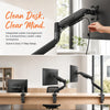 A black premium single monitor desk mount with a gas spring arm is shown mounted to a desk.