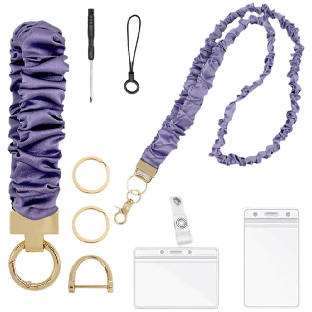 Purple stretchy breakaway ID badge lanyard with a gold clip and retractable reel.