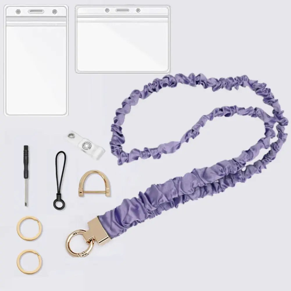Purple stretchy breakaway ID badge lanyard with a gold-colored retractable reel and various accessories