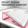 A pink acrylic keyboard riser stand featuring a white keyboard and an ergonomic wrist rest, shown at an angle.