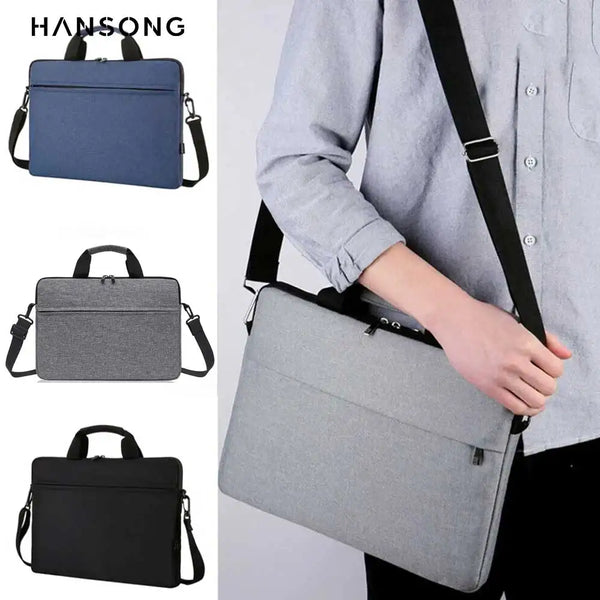 A person is carrying a gray nylon laptop tote bag with black straps over their shoulder.