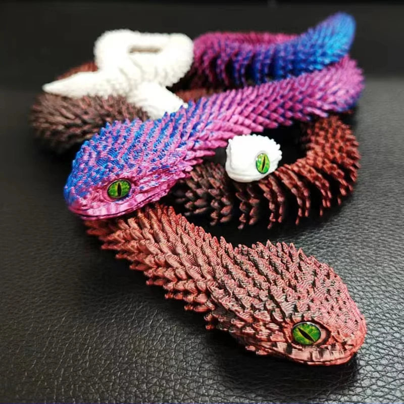 A collection of colorful, textured snake figurines made from yarn or fiber art displayed on a dark surface.