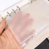 A hand holds a clear PVC zipper binder with pockets for cash and small items.