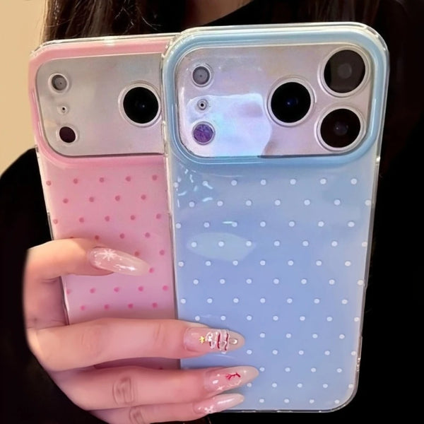 A hand holds a clear silicone phone case with a pink and blue gradient and polka dots.
