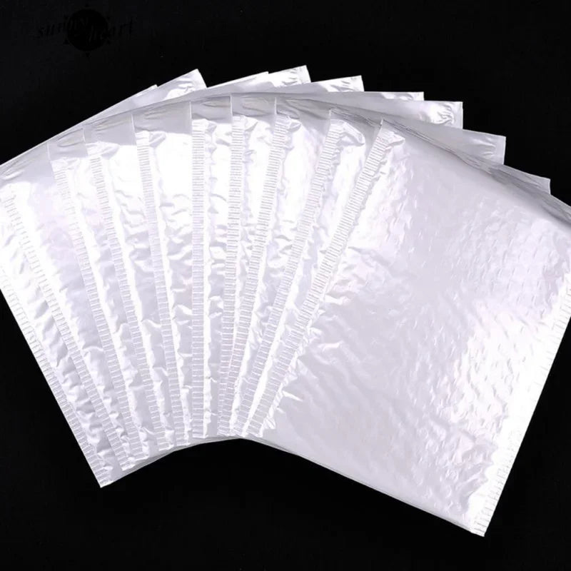 A fan of white self-sealing pearl film bubble shipping bags arranged in a semi-circle.