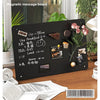 A black magnetic message board used as a professional table shelf with various notes and items displayed.