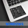 A close-up of a laptop keyboard showing a Windows shortcut quick reference sticker for various keyboard commands.