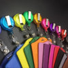 A collection of colorful PU leather retractable ID card holders in various shades including blue, yellow, green, orange, pink