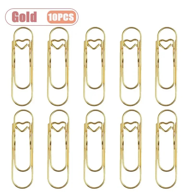 Ten gold metal pen clips designed for holding notebooks and journals