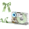 A clear label maker device with a ribbon and roll of pastel green labels and a bow.