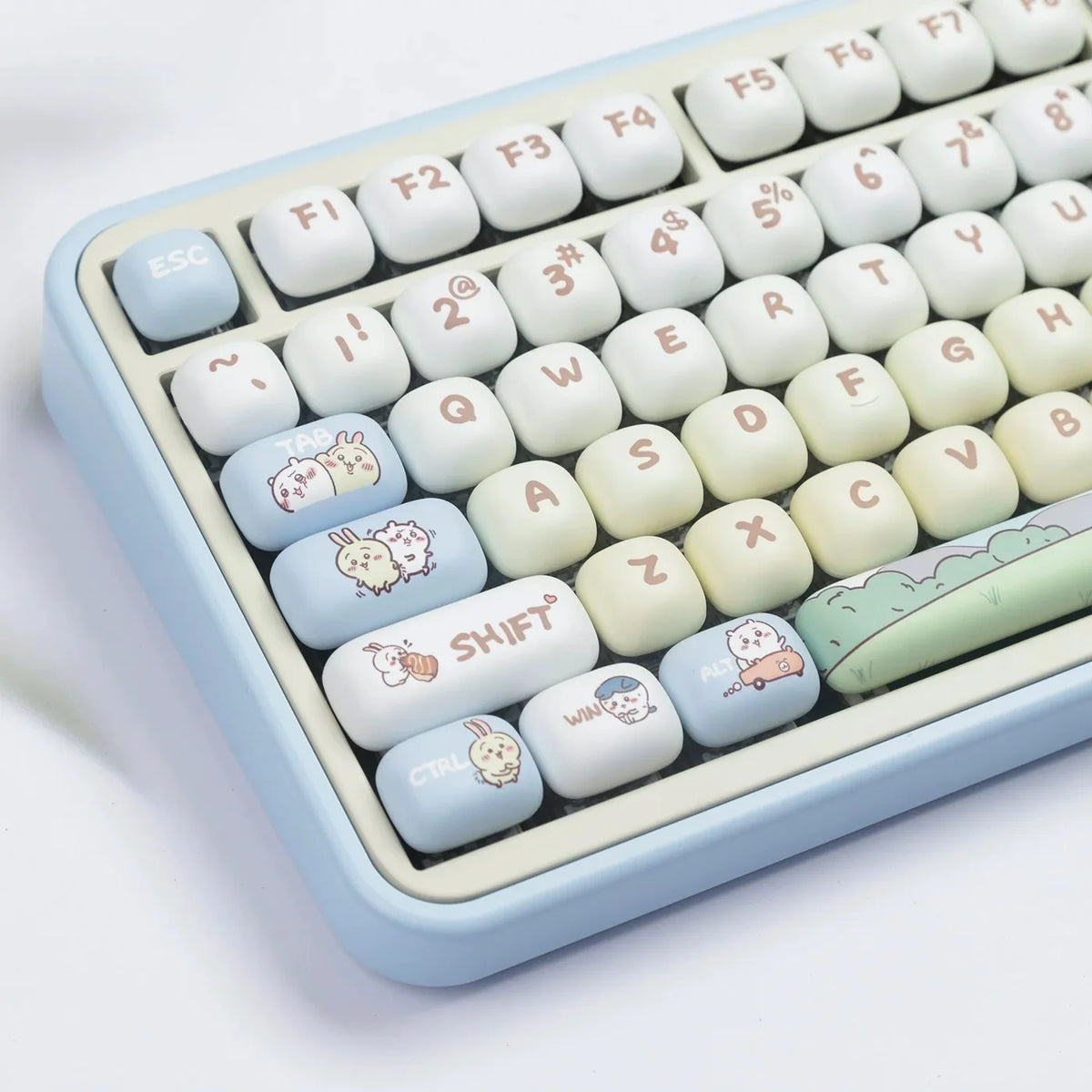 A close-up view of light blue dye-sublimated PBT keycaps for a mechanical keyboard, showing various white and light blue char