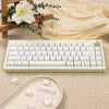 A custom printed white jelly keycap is shown next to a mechanical keyboard and loose keycaps on a beige fabric surface.