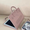 A pink laptop sleeve with a handle and protective PU case is shown next to a laptop.
