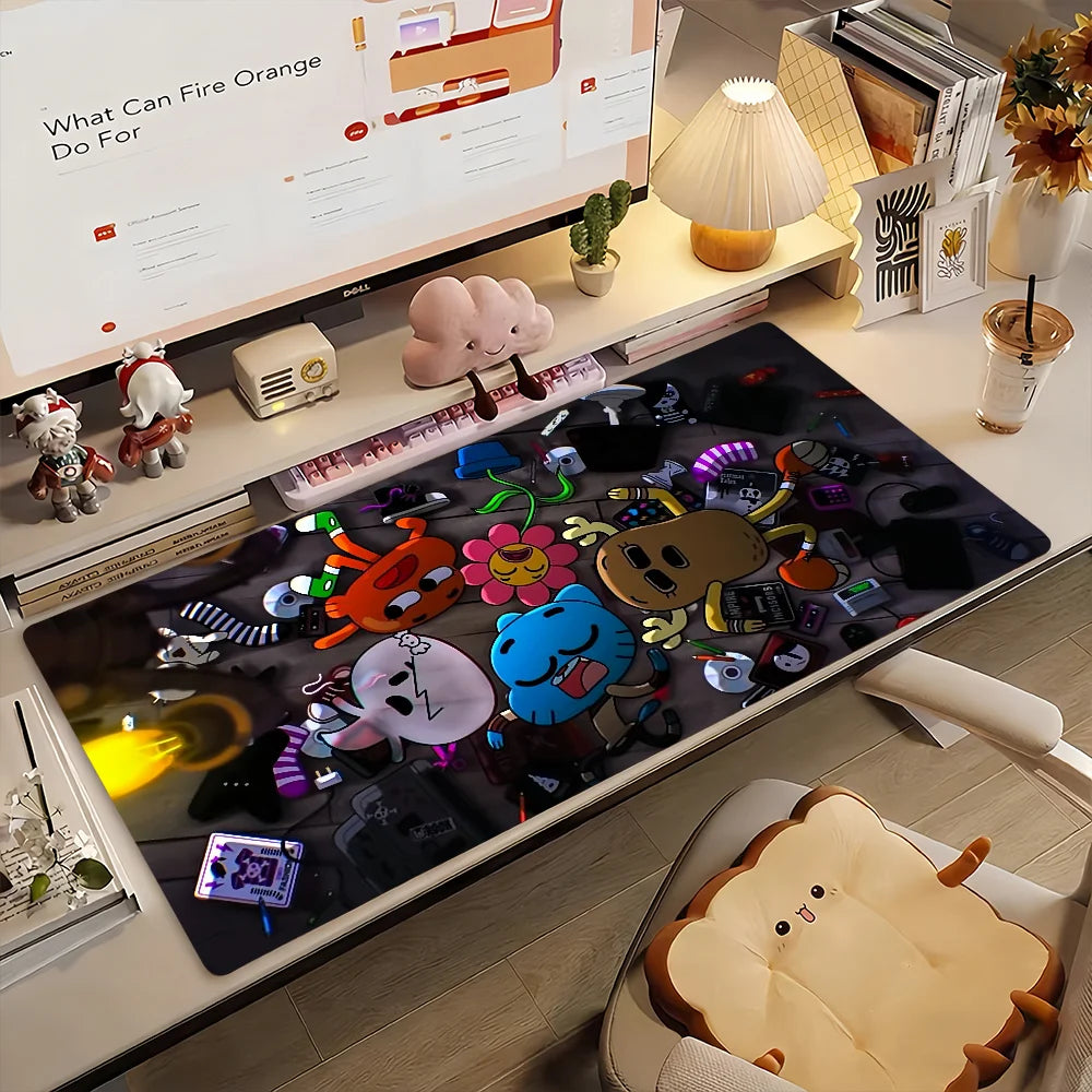 A dark mouse pad featuring various cartoon characters and designs, displayed next to a monitor.