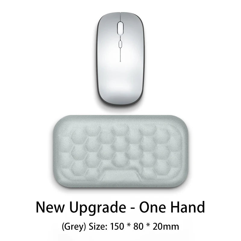 A grey ergonomic mouse wrist rest pad with a smooth top and a textured, rectangular base.