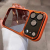 An orange clear shockproof case with multiple camera lenses is held in a hand against a light background.