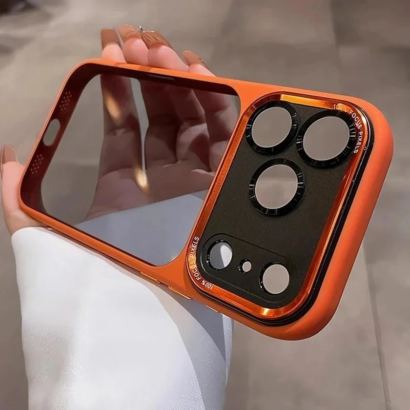 An orange clear shockproof case with multiple camera lenses is held in a hand against a light background.