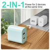 A light blue portable charger with dual USB-C ports is shown on a wooden table.