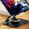 A hand holds a tablet displaying a colorful scene, resting on a black adjustable dual rod stand.