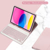 A pink iPad case is shown open with a detachable Bluetooth keyboard, resting on a white marble surface.