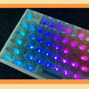 A close-up view of a set of translucent purple and blue PC keycaps for a mechanical keyboard.