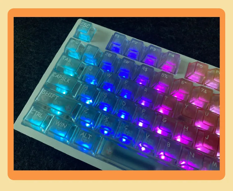 A close-up view of a set of translucent purple and blue PC keycaps for a mechanical keyboard.